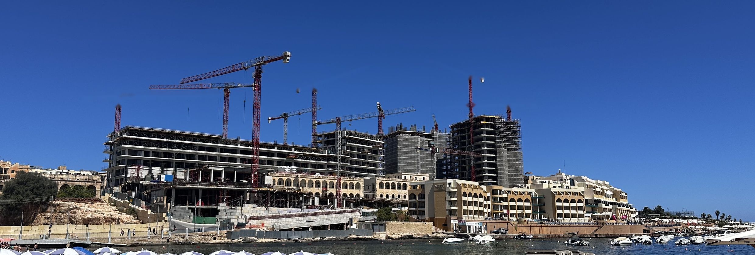 The St George's Bay hotel and residential towers under construction, seen from the beach across the bay